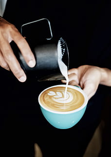 Person Pouring Coffee Latte on Ceramic Mug, barista, beverage HD wallpaper