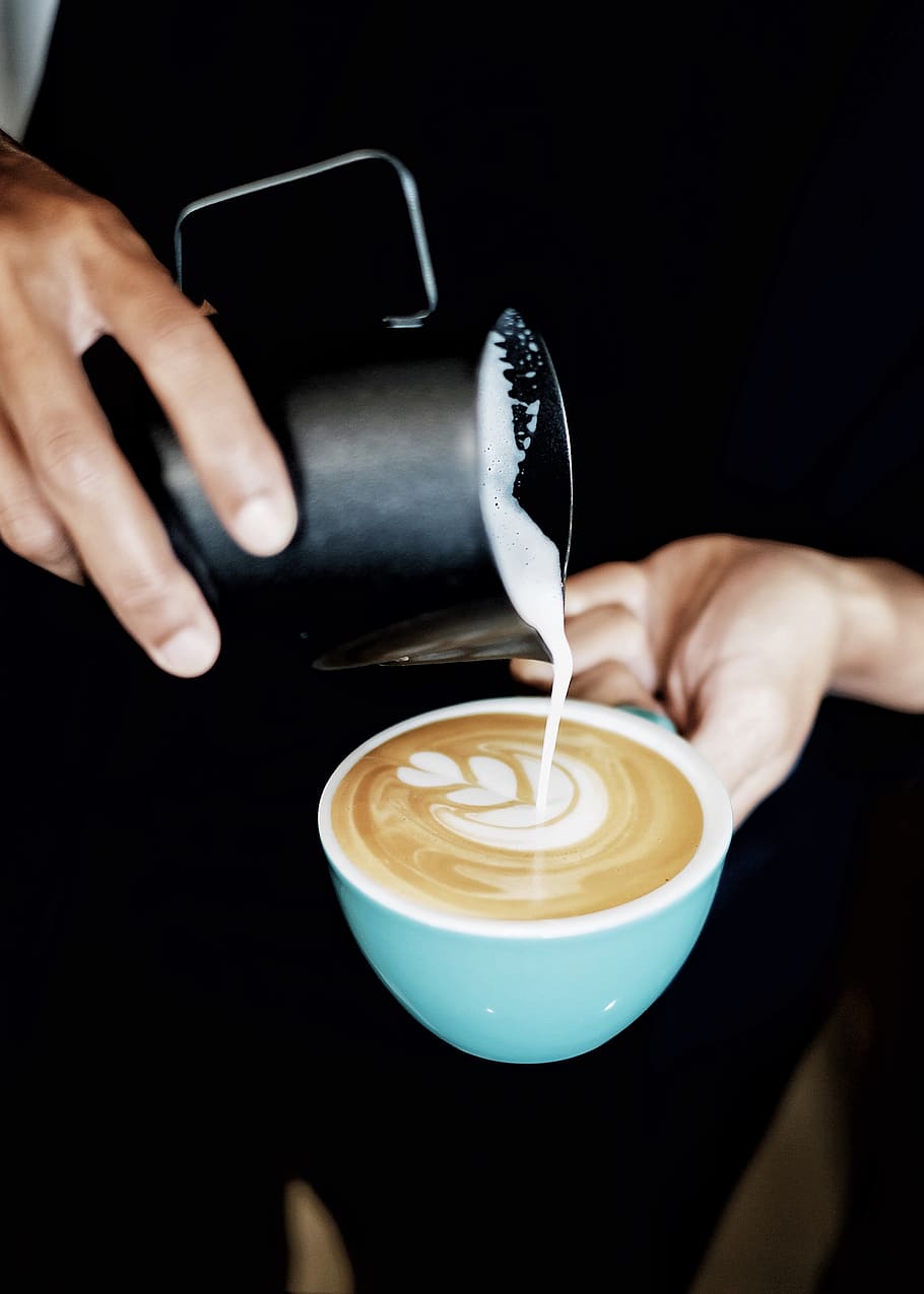 Person Pouring Coffee Latte on Ceramic Mug, barista, beverage