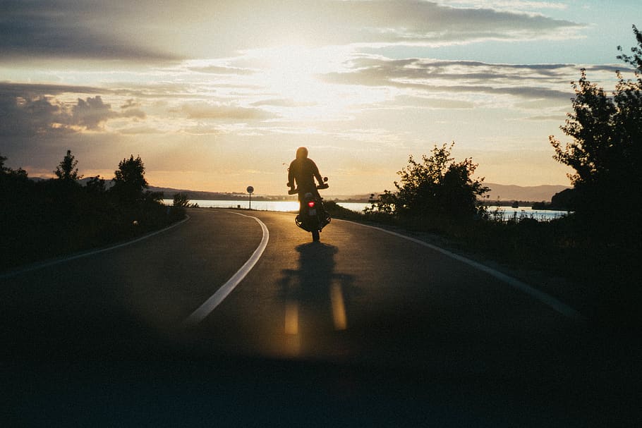 Person Riding Motorcycle during Golden Hour, asphalt, backlit HD wallpaper