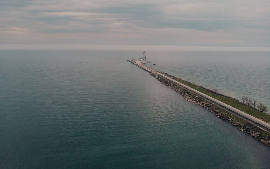 Aerial view of a road leading to a large seaport with horizon in the background HD wallpaper