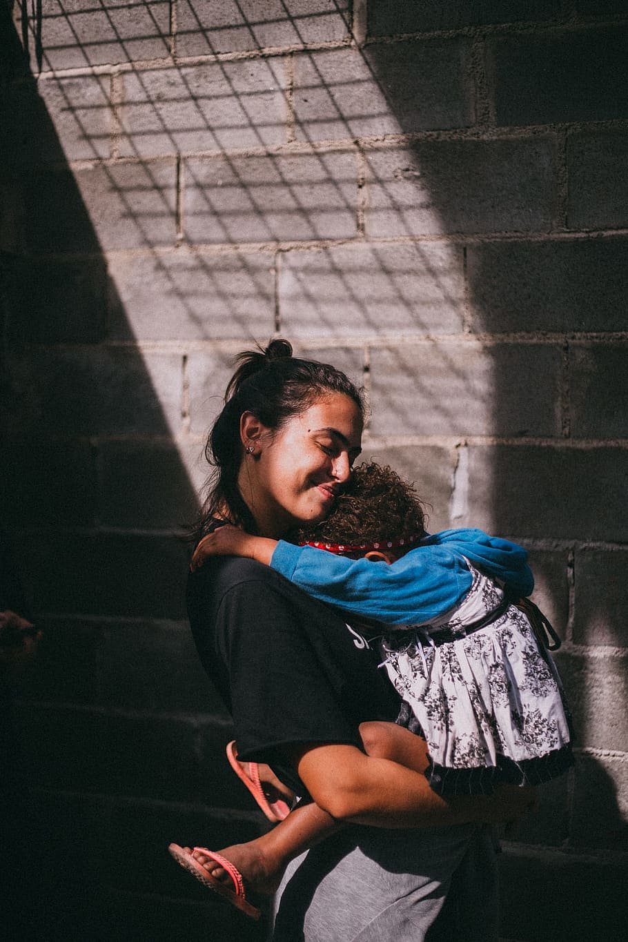 Woman Holding Girl Beside Gray Wall, adorable, affection, care HD wallpaper