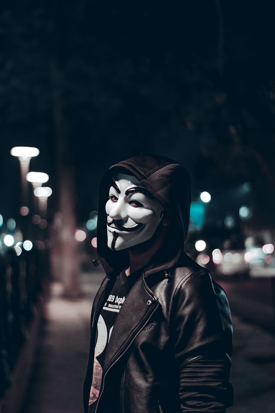 Person Wearing Guy Fawkes Mask, black leather jacket, blur, city lights