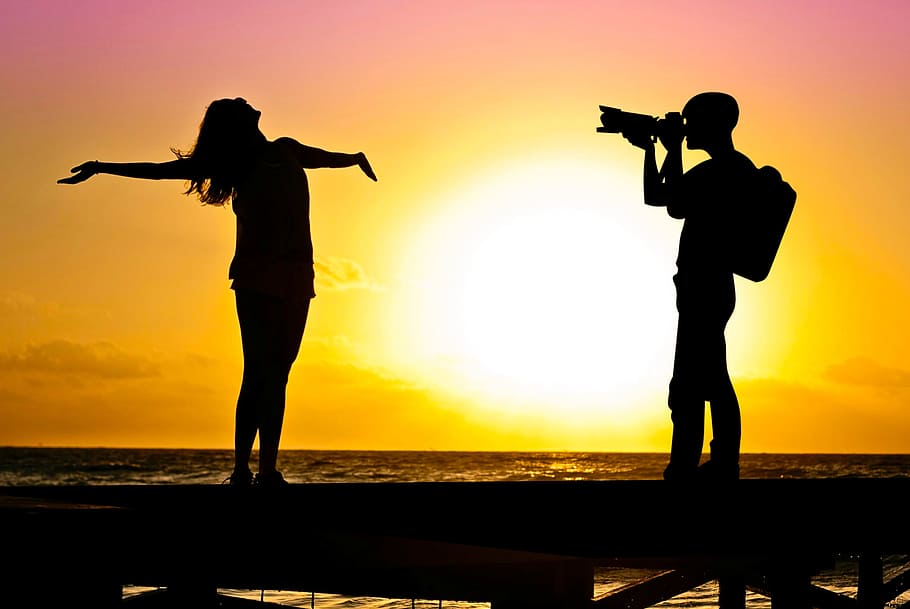 Photo illustration of photographer shooting photo of model on the beach. HD wallpaper