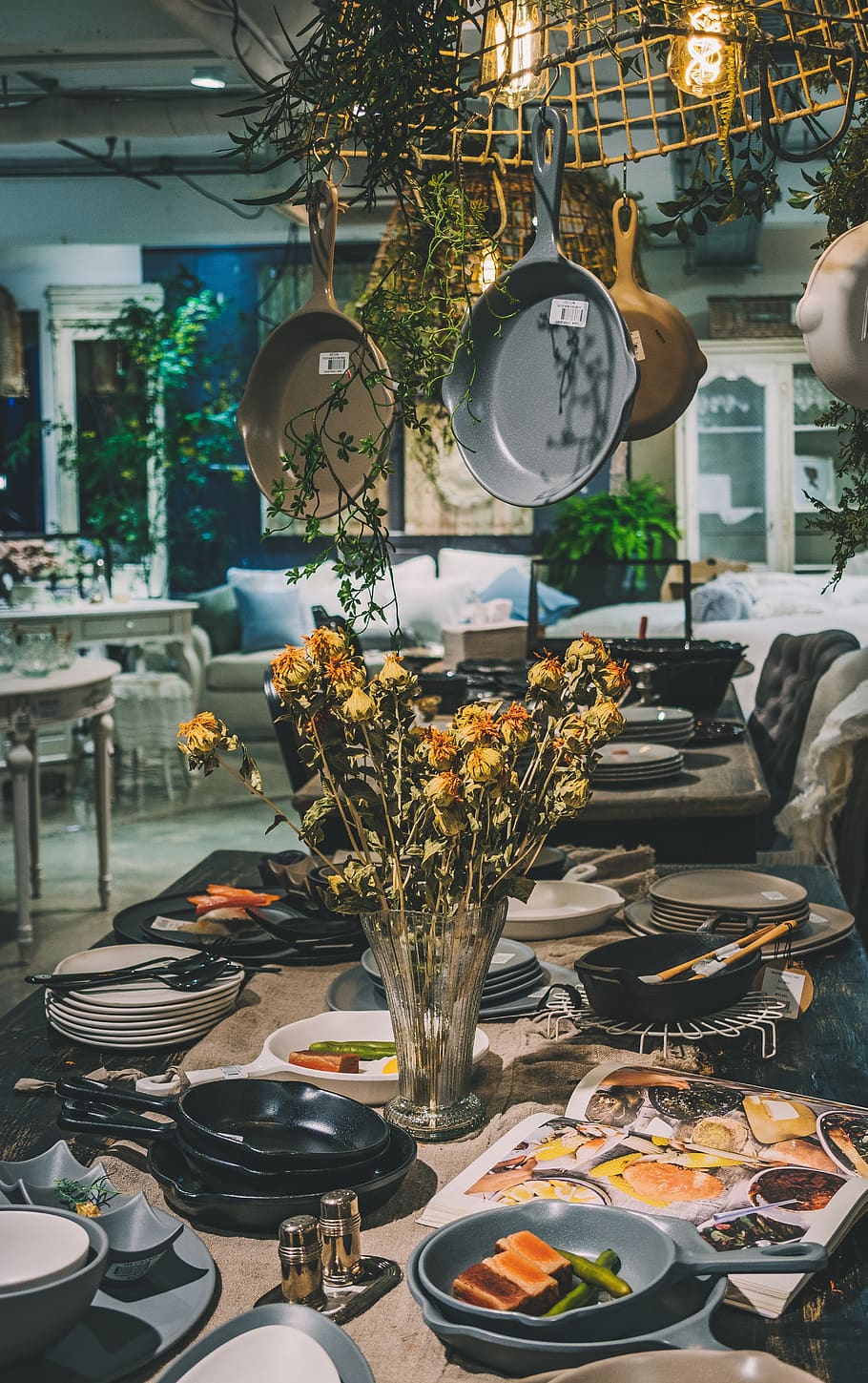 yellow-petaled flowers surrounded by dinnerware set, indoors
