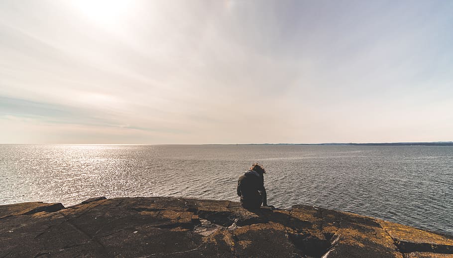 Person Sitting on Stone in Front of Sea Water, beach, bright HD wallpaper