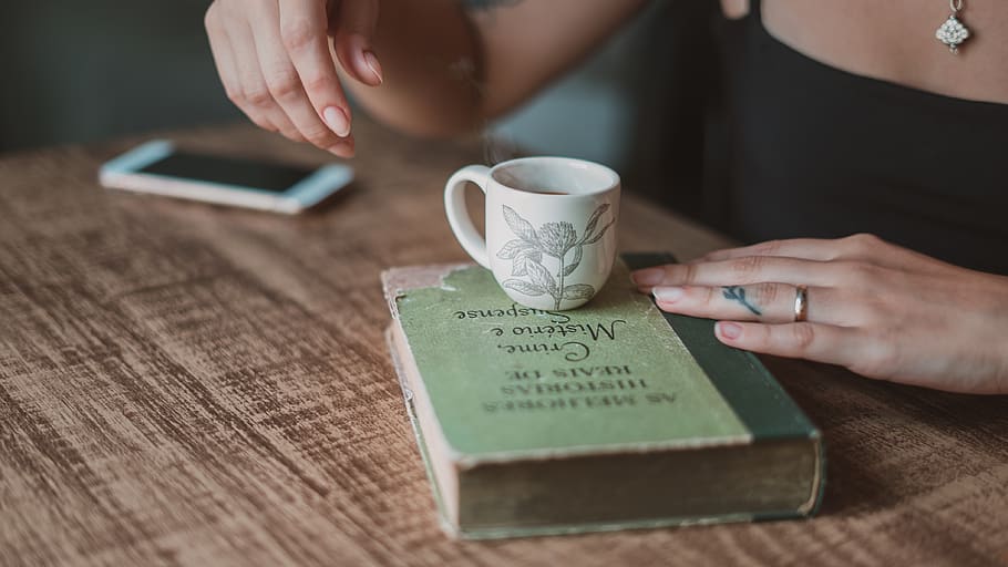 teacup on book, human hand, human body part, communication, one person HD wallpaper