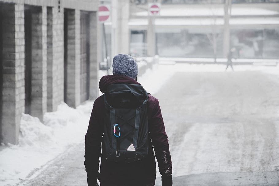 man wearing black hoodie and grey beanie walking on snow covered road, HD wallpaper