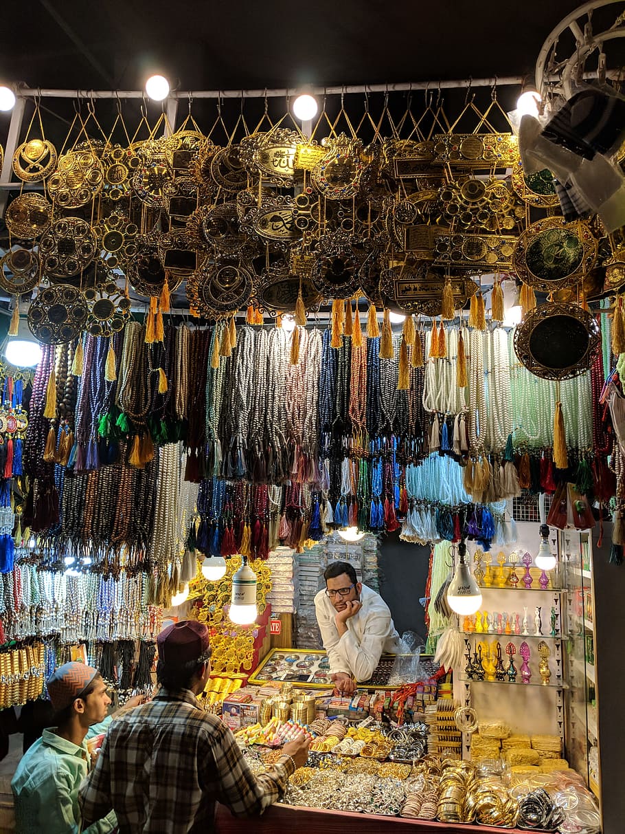 Three Men Surrounded With Jewelries during Nighttime, bazaar HD wallpaper