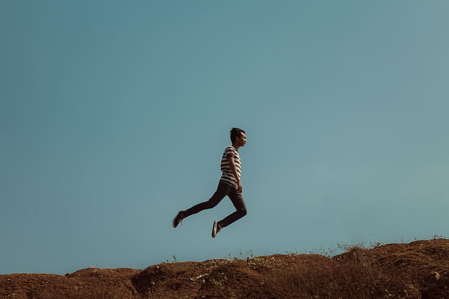 Man Jumping Near the Cliff, action, adventure, daylight, dom HD wallpaper