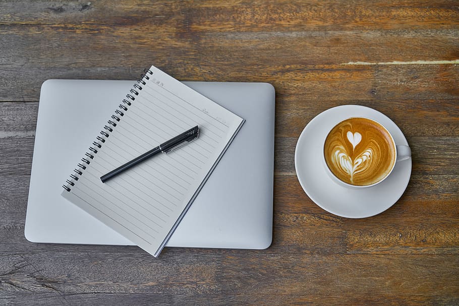 Teacup of Latte on Saucer Beside Notebook, brown, caffeine, close-up HD wallpaper