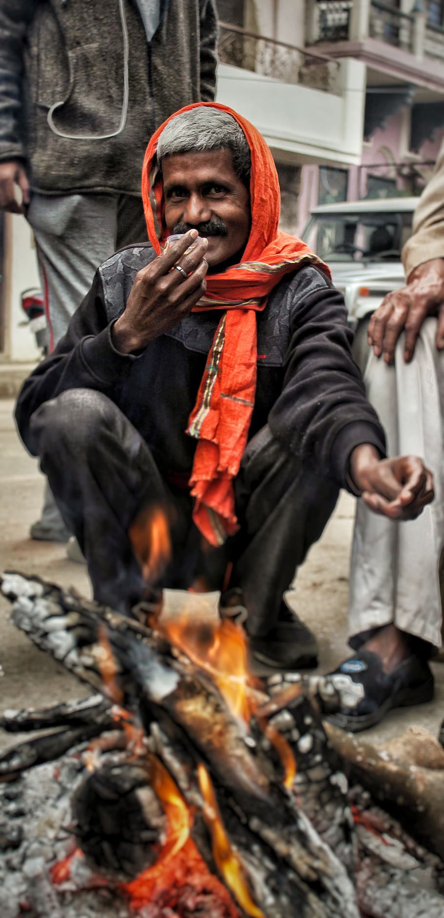 man sitting near bone fire, human, person, flame, bonfire, apparel