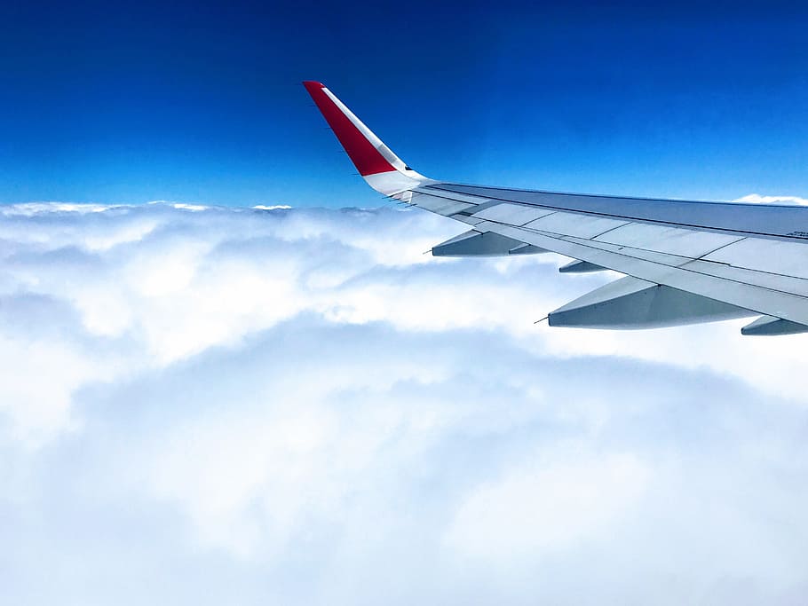 white and red airplane wing above cloudy skies, sky, above the clouds HD wallpaper
