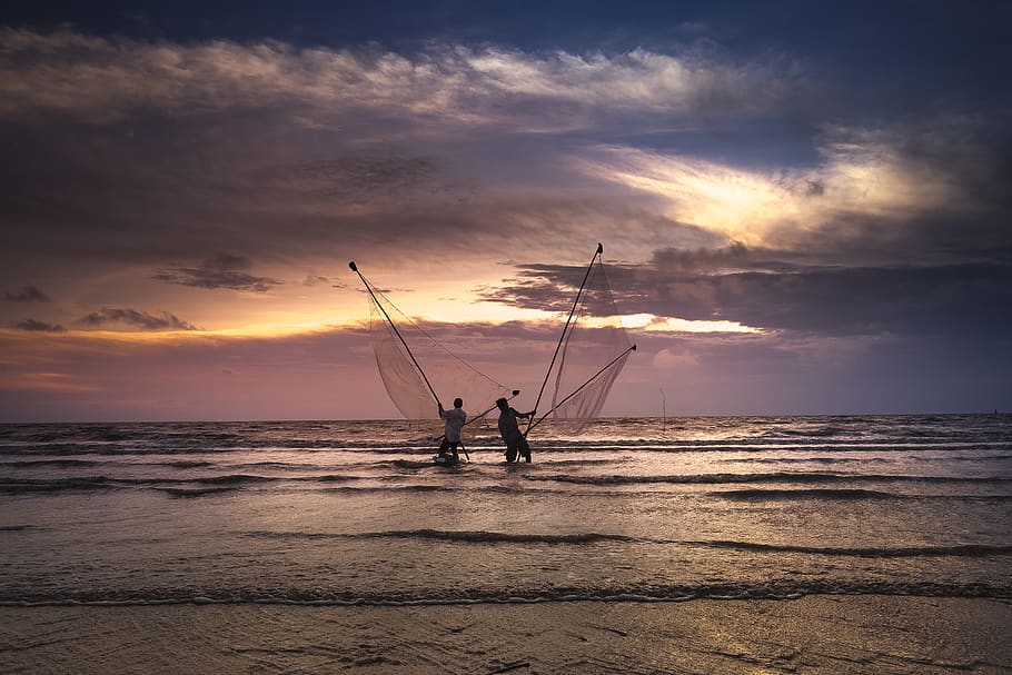 Two Men Standing on Body of Water Holding Fish Nets, beach, clouds HD wallpaper